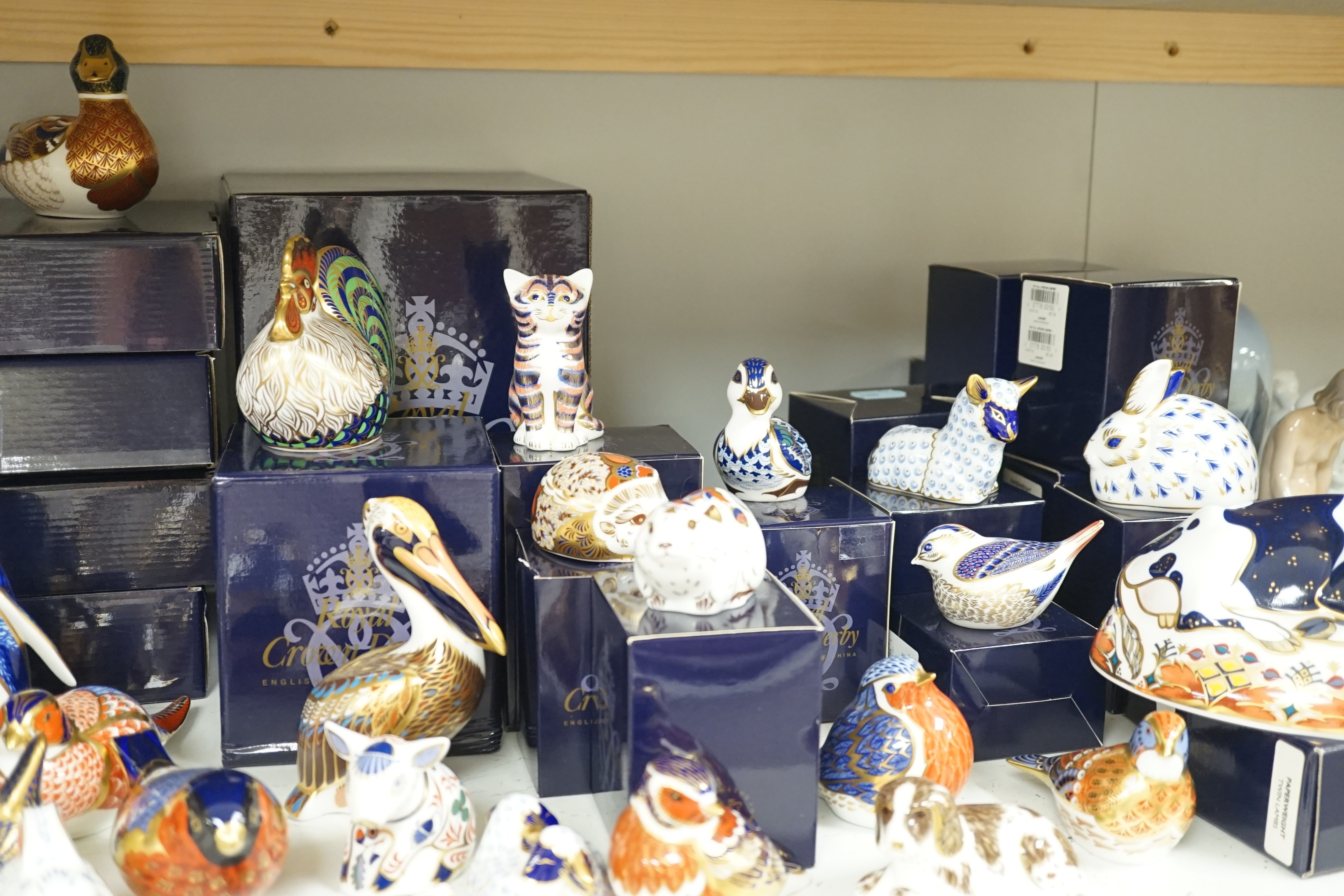 Approximately thirty-two Royal Crown Derby Imari porcelain paperweights, all but two with original boxes and mostly gold bottoms